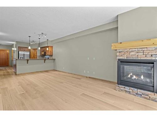 411-107 Armstrong Place, Canmore, AB - Indoor Photo Showing Living Room With Fireplace