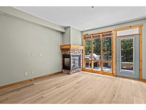 411-107 Armstrong Place, Canmore, AB - Indoor Photo Showing Other Room With Fireplace