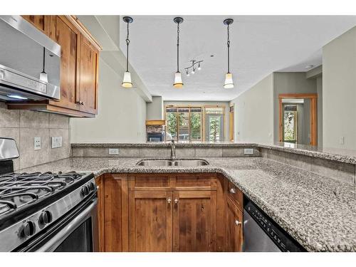 411-107 Armstrong Place, Canmore, AB - Indoor Photo Showing Kitchen With Double Sink