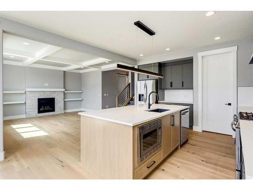 309 Coopersfield Rise Sw, Airdrie, AB - Indoor Photo Showing Kitchen With Fireplace