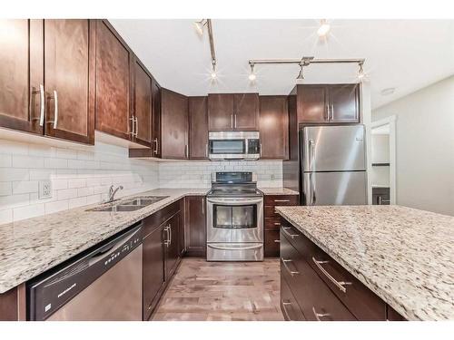 705 Mckenzie Towne Square Se, Calgary, AB - Indoor Photo Showing Kitchen With Double Sink