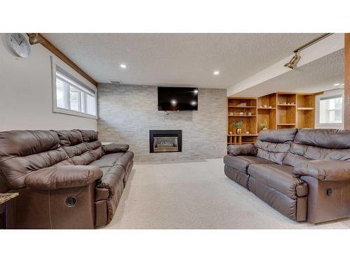 4855 Rundlewood Drive Ne, Calgary, AB - Indoor Photo Showing Living Room With Fireplace