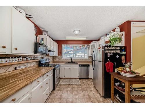 8 Alpine Crescent Se, Airdrie, AB - Indoor Photo Showing Kitchen With Double Sink