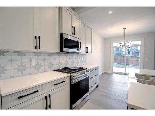 44 Precedence View, Cochrane, AB - Indoor Photo Showing Kitchen With Double Sink With Upgraded Kitchen