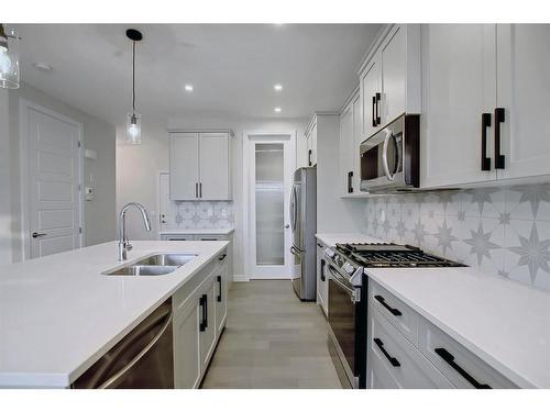 44 Precedence View, Cochrane, AB - Indoor Photo Showing Kitchen With Double Sink With Upgraded Kitchen