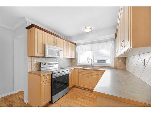 112 Baird Avenue, Cochrane, AB - Indoor Photo Showing Kitchen With Double Sink