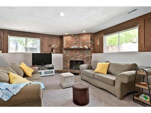 163 Wood Crest Place Sw, Calgary, AB - Indoor Photo Showing Living Room With Fireplace