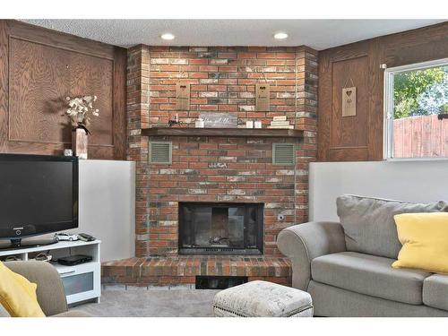 163 Wood Crest Place Sw, Calgary, AB - Indoor Photo Showing Living Room With Fireplace