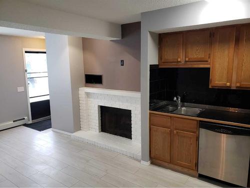 1-1603 16 Avenue Sw, Calgary, AB - Indoor Photo Showing Kitchen With Fireplace With Double Sink