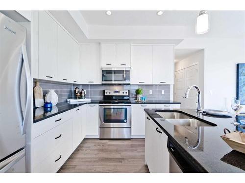 425-115 Sagewood Drive, Airdrie, AB - Indoor Photo Showing Kitchen With Stainless Steel Kitchen With Double Sink With Upgraded Kitchen