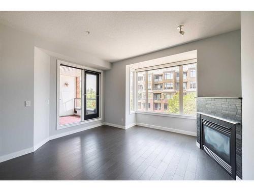 305-1000 Centre Avenue Ne, Calgary, AB - Indoor Photo Showing Other Room With Fireplace