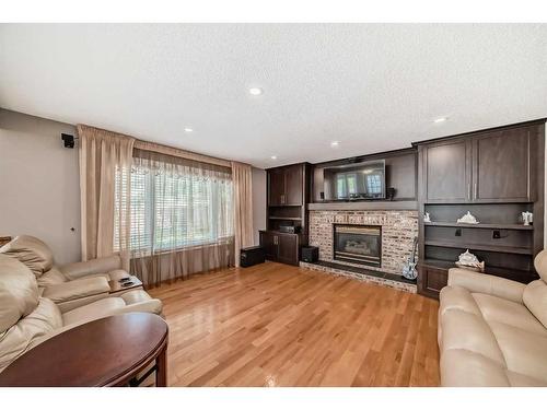 8 Arbour Glen Close Nw, Calgary, AB - Indoor Photo Showing Living Room With Fireplace