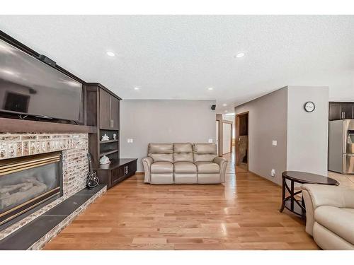 8 Arbour Glen Close Nw, Calgary, AB - Indoor Photo Showing Living Room With Fireplace