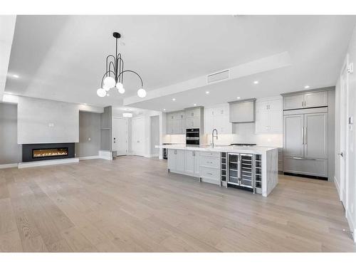 201-180 Marina Cove Se, Calgary, AB - Indoor Photo Showing Kitchen With Fireplace With Upgraded Kitchen