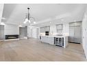 201-180 Marina Cove Se, Calgary, AB  - Indoor Photo Showing Kitchen With Fireplace With Upgraded Kitchen 