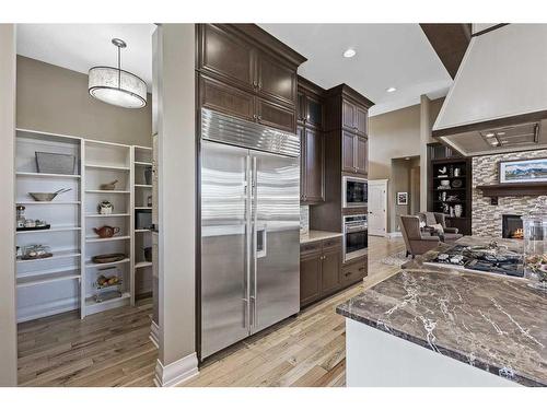 113 Silverado Crest Landing Sw, Calgary, AB - Indoor Photo Showing Kitchen With Fireplace With Upgraded Kitchen