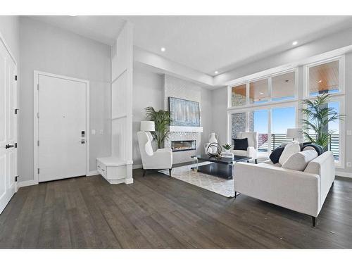 302-180 Marina Cove Se, Calgary, AB - Indoor Photo Showing Living Room With Fireplace