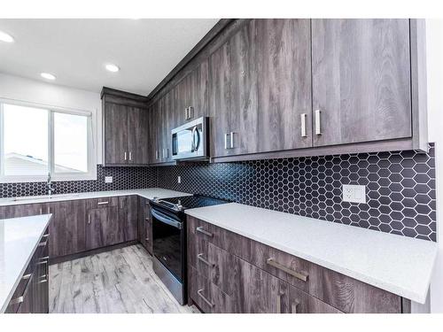 1020 Iron Landing Way, Crossfield, AB - Indoor Photo Showing Kitchen With Upgraded Kitchen