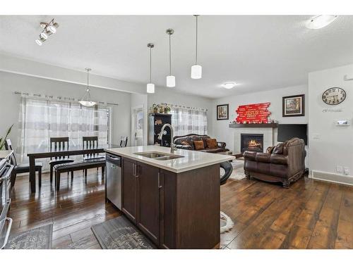 135 Masters Rise Se, Calgary, AB - Indoor Photo Showing Kitchen With Fireplace With Double Sink