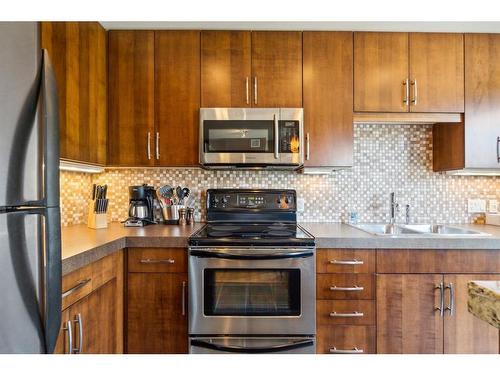 303-1818 Mountain Avenue, Canmore, AB - Indoor Photo Showing Kitchen With Double Sink