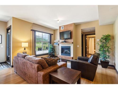 303-1818 Mountain Avenue, Canmore, AB - Indoor Photo Showing Living Room With Fireplace