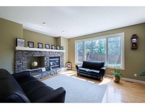 68 Tuscany Glen Road Nw, Calgary, AB - Indoor Photo Showing Living Room With Fireplace