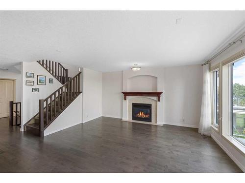 128 Tuscany Ravine Terrace Nw, Calgary, AB - Indoor Photo Showing Living Room With Fireplace