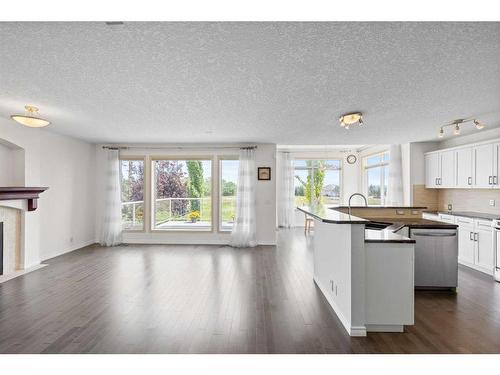 128 Tuscany Ravine Terrace Nw, Calgary, AB - Indoor Photo Showing Kitchen With Fireplace