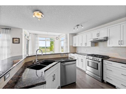 128 Tuscany Ravine Terrace Nw, Calgary, AB - Indoor Photo Showing Kitchen With Stainless Steel Kitchen With Double Sink With Upgraded Kitchen