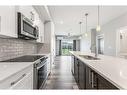 308-4150 Seton Drive Se, Calgary, AB  - Indoor Photo Showing Kitchen With Stainless Steel Kitchen With Double Sink With Upgraded Kitchen 