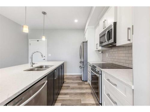 308-4150 Seton Drive Se, Calgary, AB - Indoor Photo Showing Kitchen With Stainless Steel Kitchen With Double Sink With Upgraded Kitchen