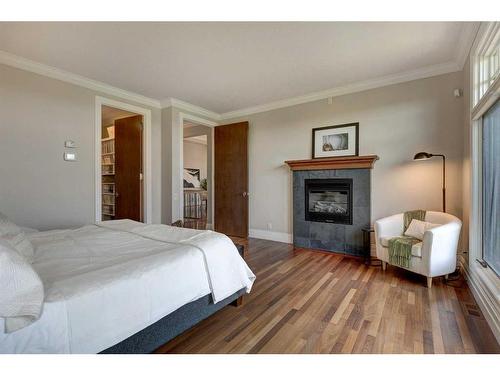90 Aspen Ridge Way Sw, Calgary, AB - Indoor Photo Showing Bedroom With Fireplace