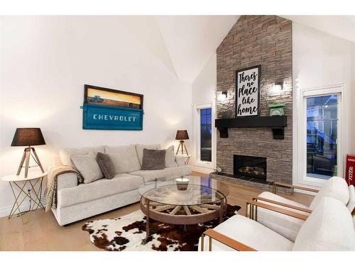 1149 Coopers Drive Sw, Airdrie, AB - Indoor Photo Showing Living Room With Fireplace