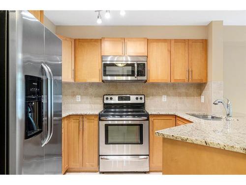 216-500 Rocky Vista Gardens Nw, Calgary, AB - Indoor Photo Showing Kitchen With Stainless Steel Kitchen With Double Sink