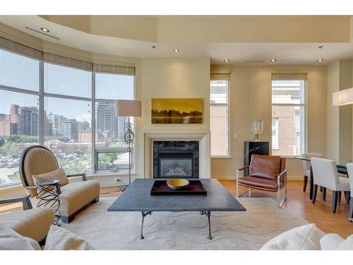 402-650 Eau Claire Avenue Sw, Calgary, AB - Indoor Photo Showing Living Room With Fireplace