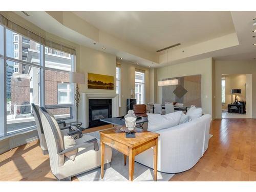 402-650 Eau Claire Avenue Sw, Calgary, AB - Indoor Photo Showing Living Room With Fireplace