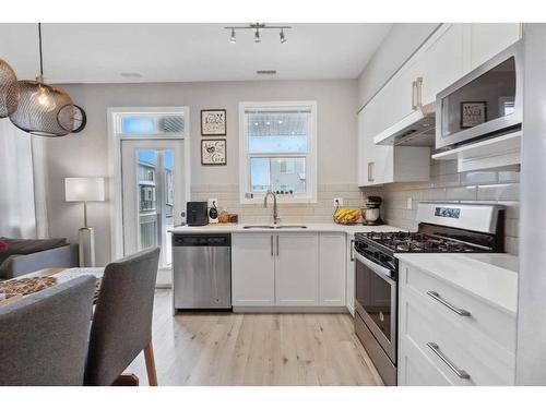 204-365 Redstone Walk Ne, Calgary, AB - Indoor Photo Showing Kitchen With Stainless Steel Kitchen With Double Sink