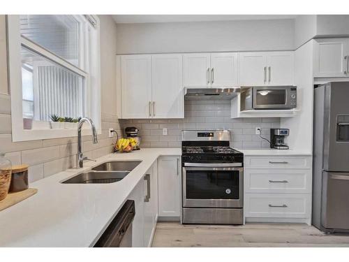 204-365 Redstone Walk Ne, Calgary, AB - Indoor Photo Showing Kitchen With Stainless Steel Kitchen With Double Sink With Upgraded Kitchen