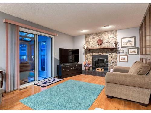 23 Cedarbrook Place Sw, Calgary, AB - Indoor Photo Showing Living Room With Fireplace