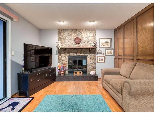 23 Cedarbrook Place Sw, Calgary, AB - Indoor Photo Showing Living Room With Fireplace