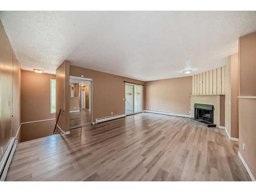 202-1119 78 Avenue Nw, Calgary, AB - Indoor Photo Showing Living Room With Fireplace