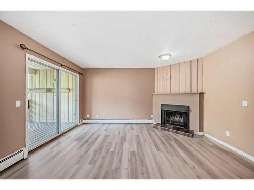 202-1119 78 Avenue Nw, Calgary, AB - Indoor Photo Showing Living Room With Fireplace