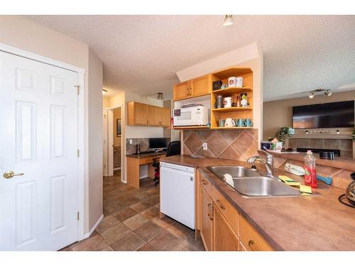 154 Bridlewood Court Sw, Calgary, AB - Indoor Photo Showing Kitchen With Double Sink