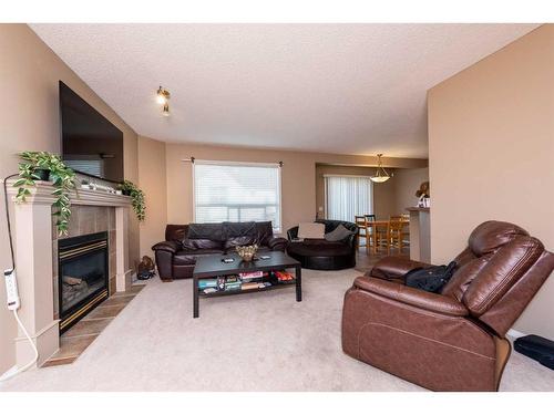154 Bridlewood Court Sw, Calgary, AB - Indoor Photo Showing Living Room With Fireplace