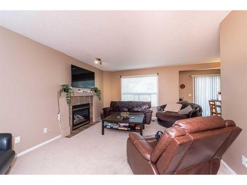 154 Bridlewood Court Sw, Calgary, AB - Indoor Photo Showing Living Room With Fireplace