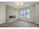 68 Shale Avenue, Cochrane, AB  - Indoor Photo Showing Living Room With Fireplace 