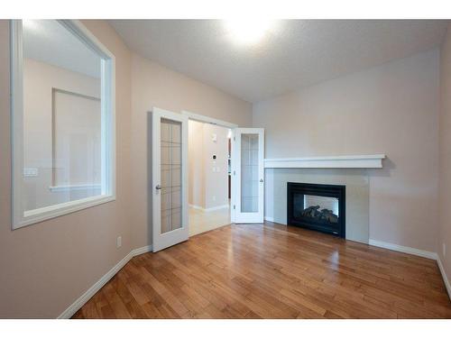 15 Cougar Ridge Rise Sw, Calgary, AB - Indoor With Fireplace