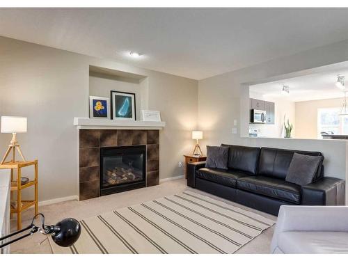 379 Silverado Drive Sw, Calgary, AB - Indoor Photo Showing Living Room With Fireplace