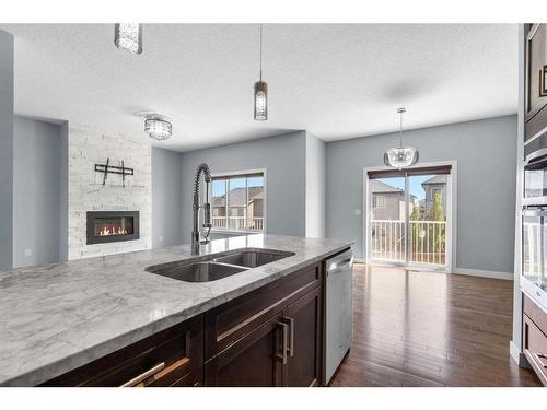 74 Nolanhurst Rise Nw, Calgary, AB - Indoor Photo Showing Kitchen With Fireplace With Double Sink