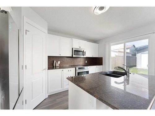 108 Silverado Plains View Sw, Calgary, AB - Indoor Photo Showing Kitchen With Double Sink